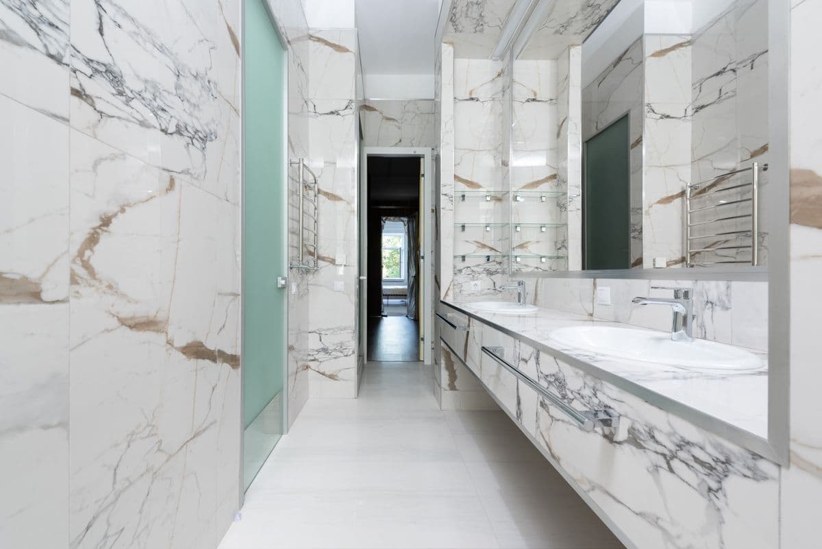 Marble bathroom with a contemporary double vanity.