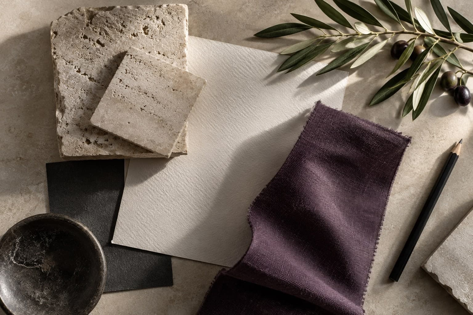 Illustrative hospitality material palette on a studio table.